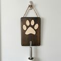 Wooden wall hook with a paw print design on a white background