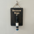 Wooden sign with 'Because Dogs' text and a roller on a white background